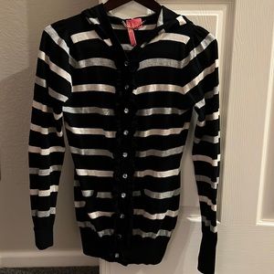 Charlotte Tarantola hoodie sweater with jewel like buttons and ruffle placket.